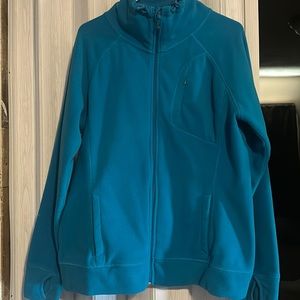 Teal soft slightly stretchy spring jacket. Arm sleeves have thumb holes